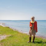 Frau an der Steilküste mit der Ostsee im Hintergrund