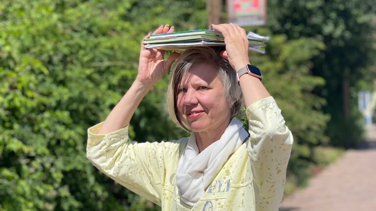 Lerncoach, blonde Frau mit Büchern auf dem Kopf
