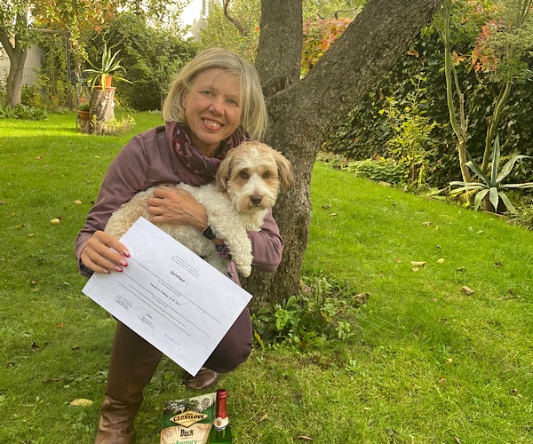 Hundehalterin mit Bolonka Zwetna und Zertifikat Therapiebegleithund im Garten