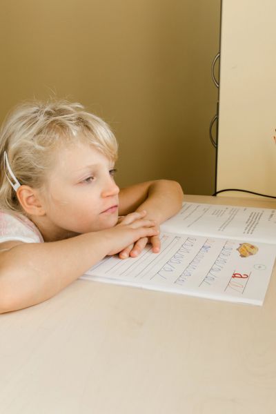 Hochbegabung erkennen: Mädchen sitzt gelangweilt am Schreibtisch