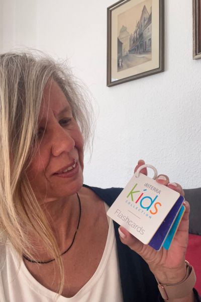Prüfungsangst bei Kindern: Frau zeigt auf ein kleines Ringbüchlein zur kids collection von doterra